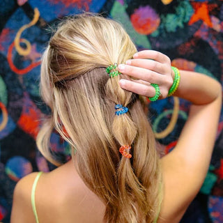 TELETIES Tiny Hair Ties in You Glow Girl Colors. Bright Fun multi pack hair ties. 
These mini hair coils are designed to fit an adult finger like a ring rather than a bracelet, offering a strong, damage-free grip that keeps hair in place all day—without breakage, creases, or headaches.